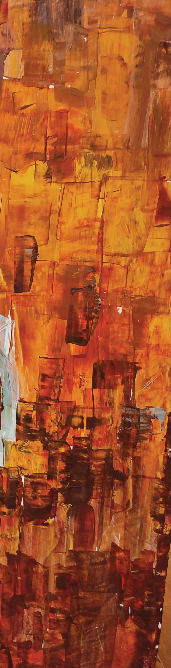 Layers of orange and gold paint on the decorated pillar.