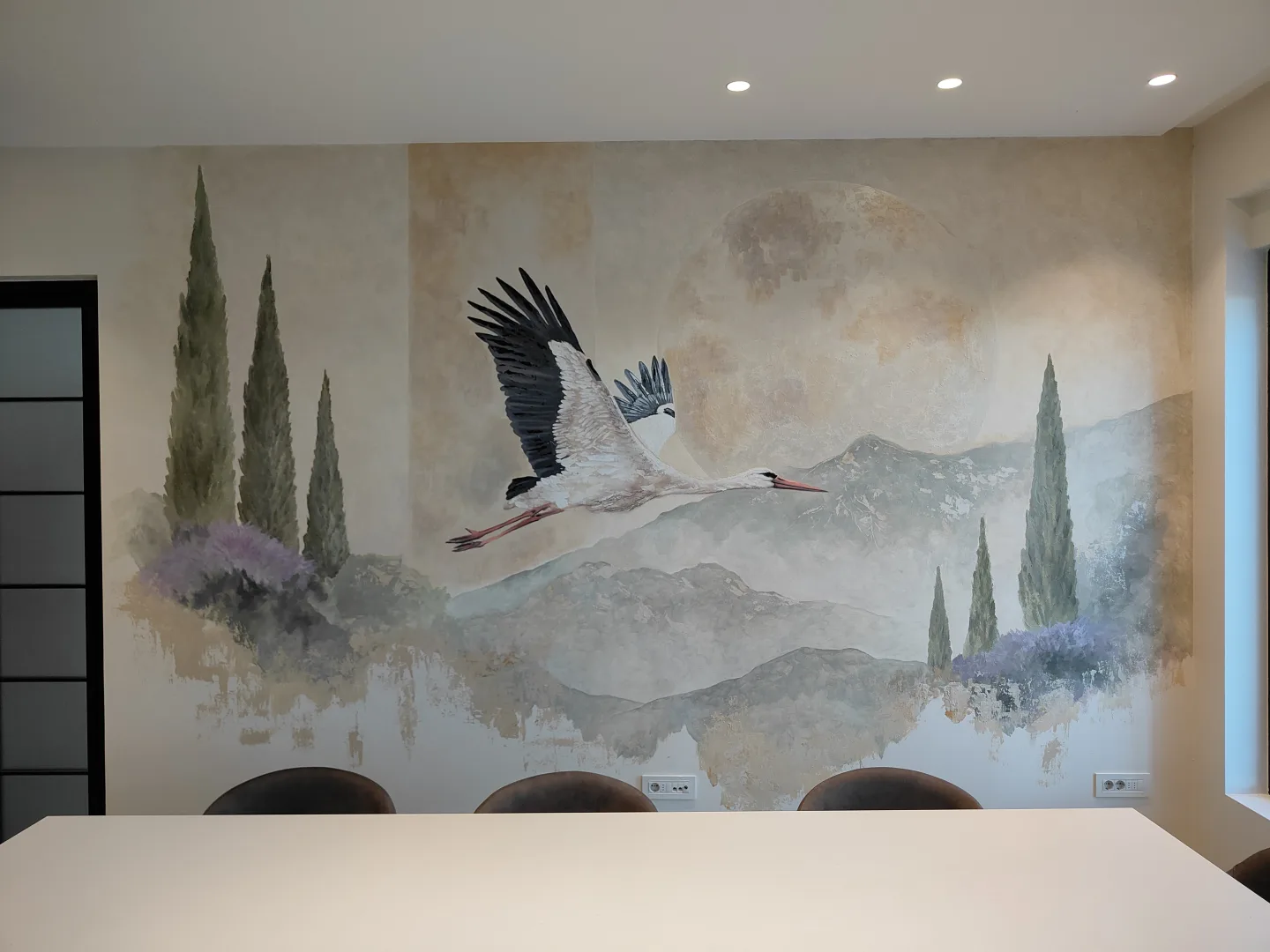 Full view of the stork mural above the dining table.