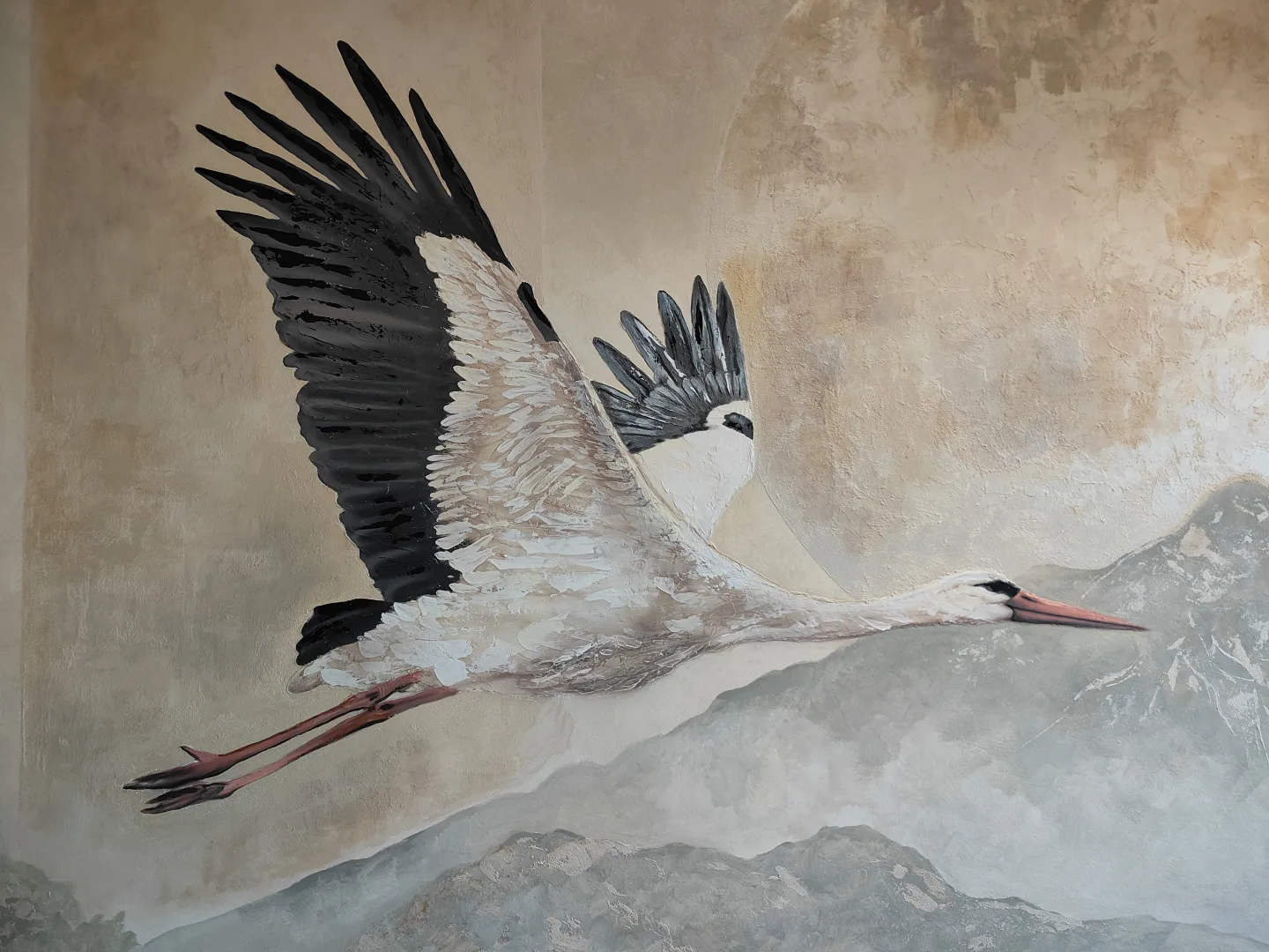 Close-up of the stork in flight in the apartment mural.