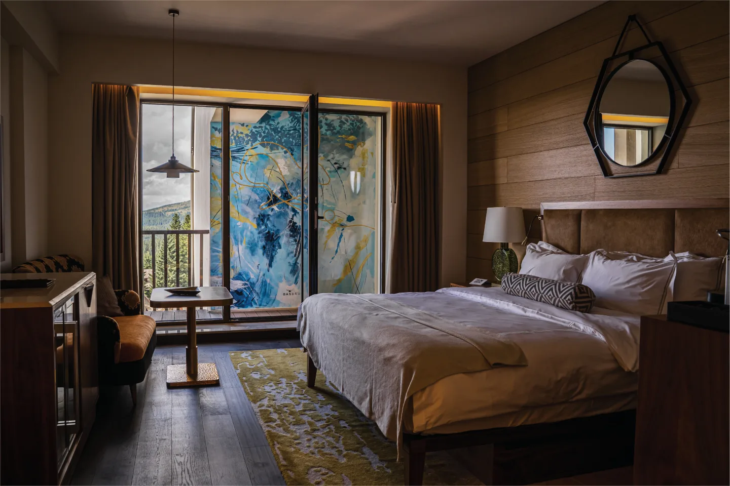 Hotel bedroom opening onto the blue and gold terrace mural.