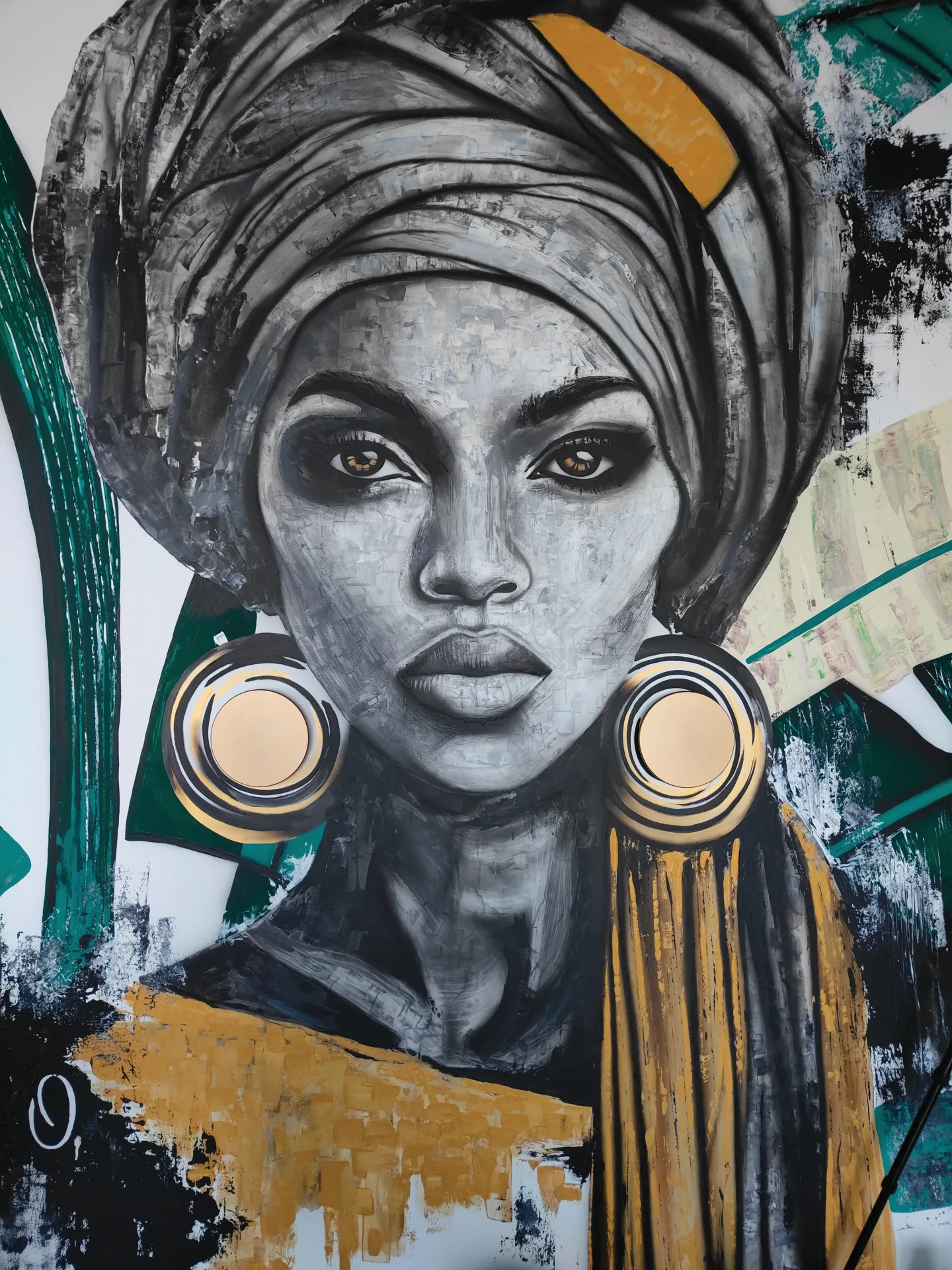 Detail of the painted face, headwrap and illuminated earrings.