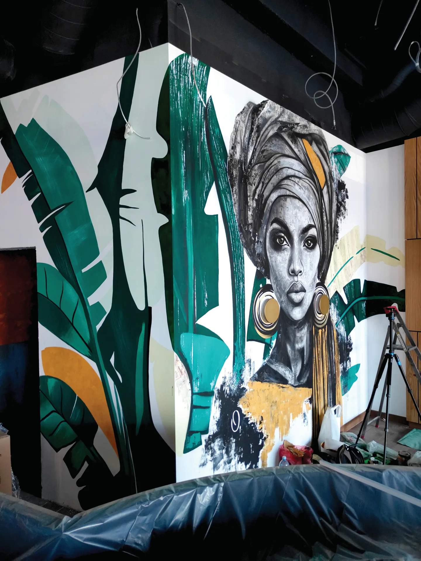 Angled view of the portrait and green botanical shapes at Lady K3.