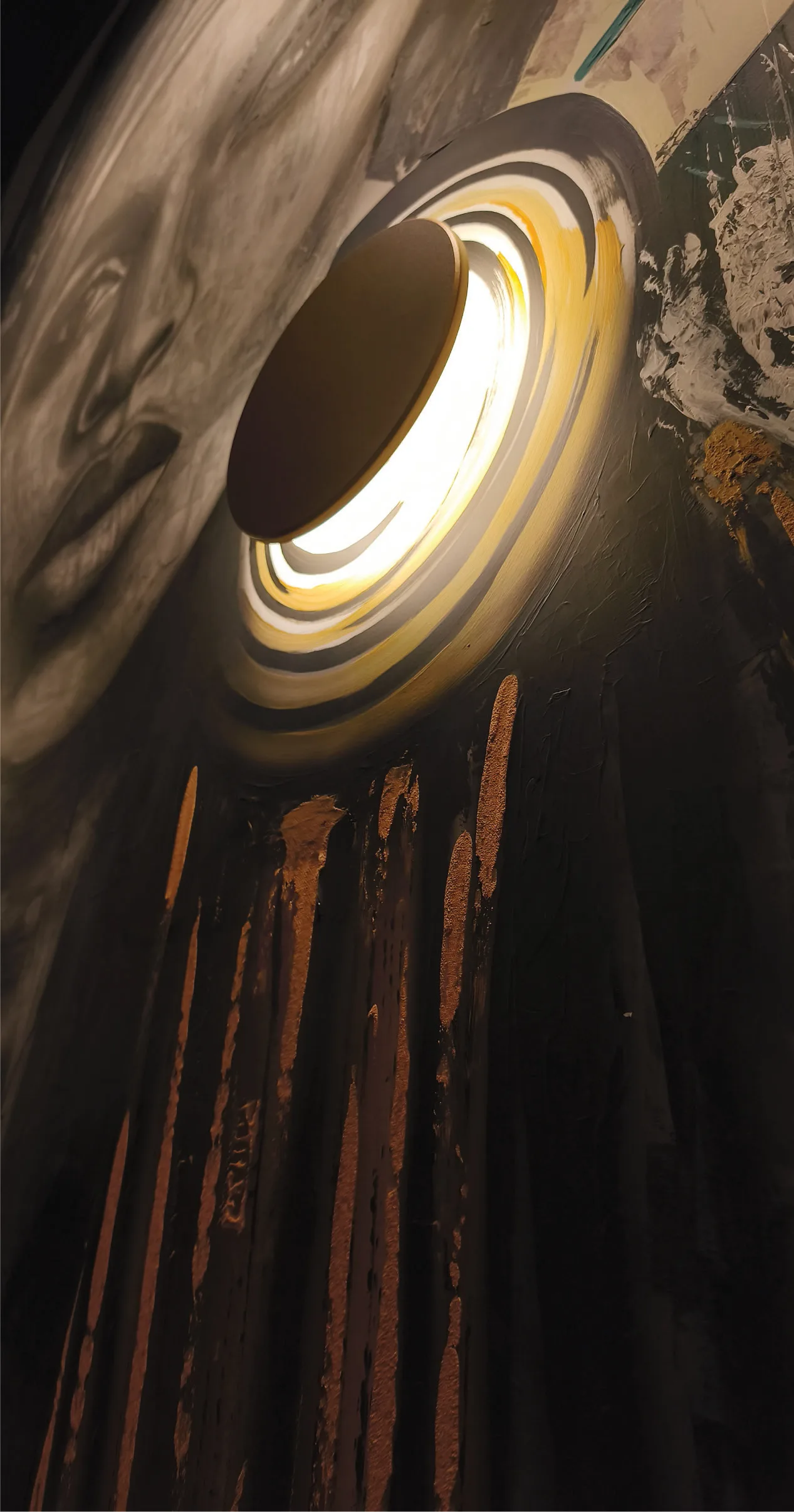 Close-up of an illuminated circular earring integrated into the mural.