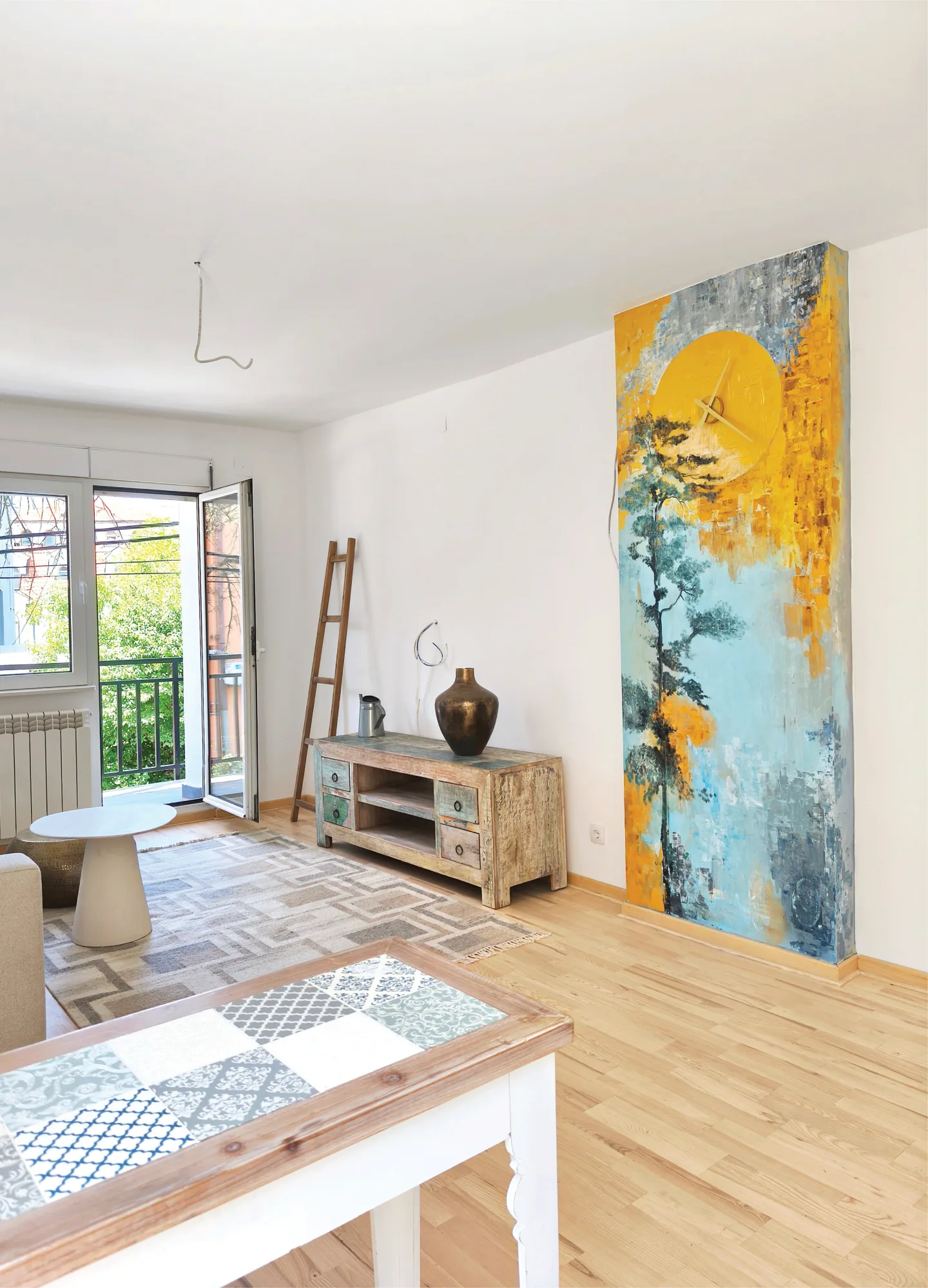 Apartment interior with a blue and gold mural and integrated wall clock.